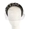 Black headband with face veil by Max Alexander
